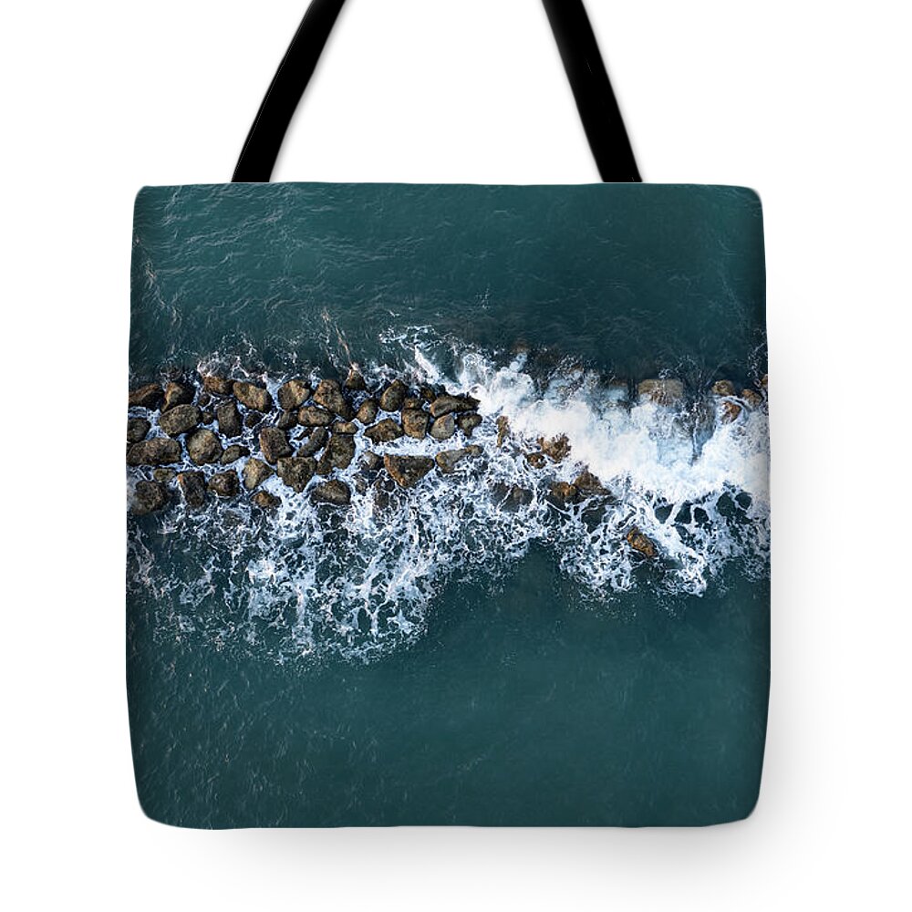 Ocean Tote Bag featuring the photograph Aerial view from a flying drone of blue sea water and break water. Sea wall coastline by Michalakis Ppalis
