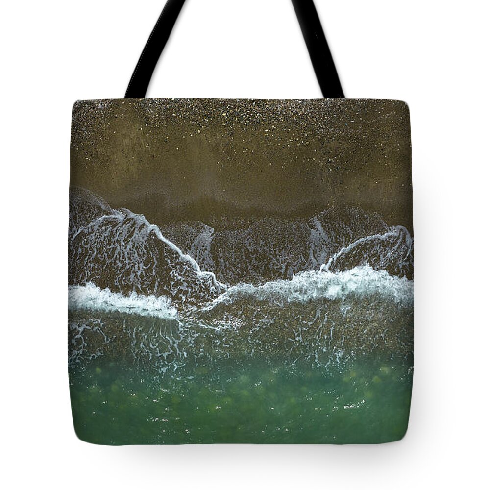 Waves Tote Bag featuring the photograph Aerial view ocean waves braking on a sandy beach. Nature background by Michalakis Ppalis