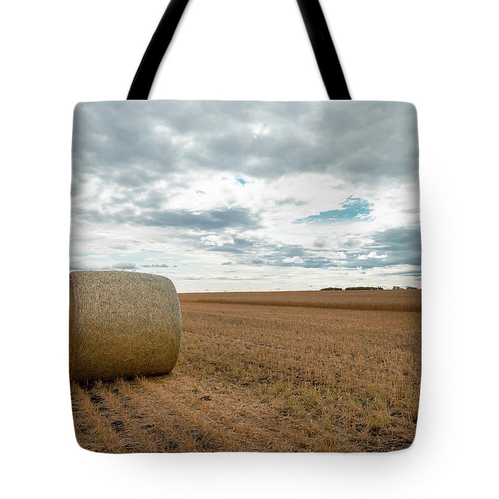 Harvest Tote Bag featuring the photograph After the wheat harvest in Alberta by Phil And Karen Rispin