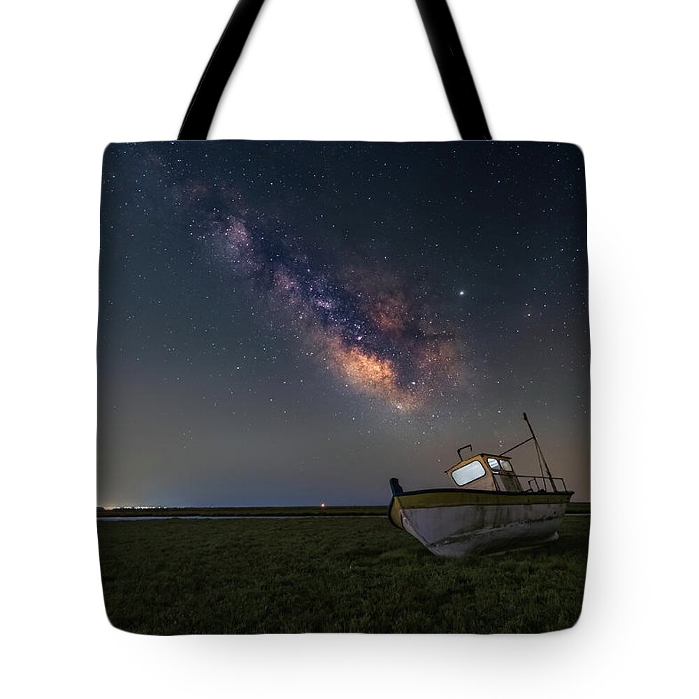Milky Way Tote Bag featuring the photograph An old boat under the milkyway by Alexios Ntounas