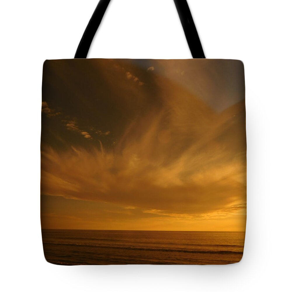 Beach Tote Bag featuring the photograph Angelic Sunset by Karen Stansberry