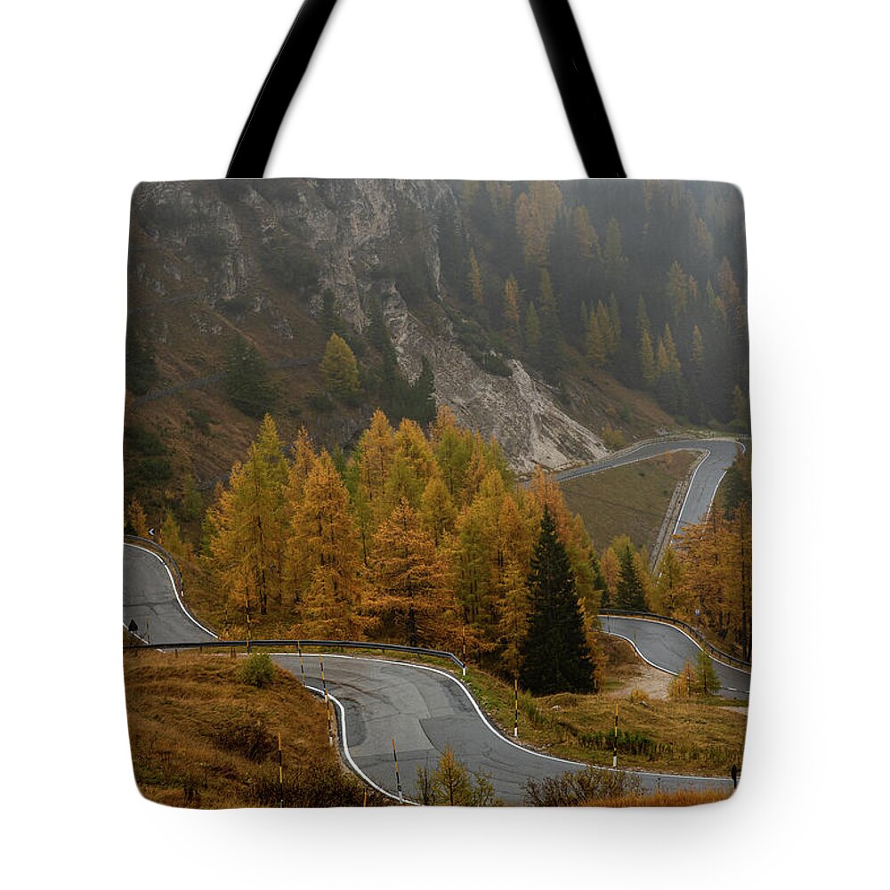 Italian Alps Tote Bag featuring the photograph Autumn landscape with curved road. Passo di falzarego South Tyrol in Italy by Michalakis Ppalis
