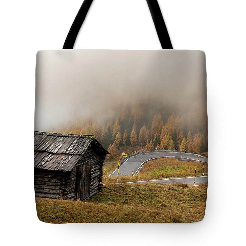 Passo Gardena Tote Bag featuring the photograph Autumn landscape with wooden chalet dolomiti Italian Apls by Michalakis Ppalis