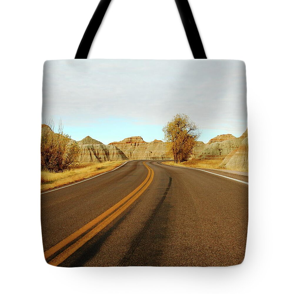 Badlands National Park Tote Bag featuring the photograph Badland Blacktop by Lens Art Photography By Larry Trager