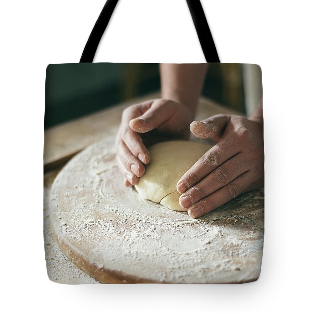 Baker Tote Bag featuring the photograph Baker preparing dough closeup by Jelena Jovanovic