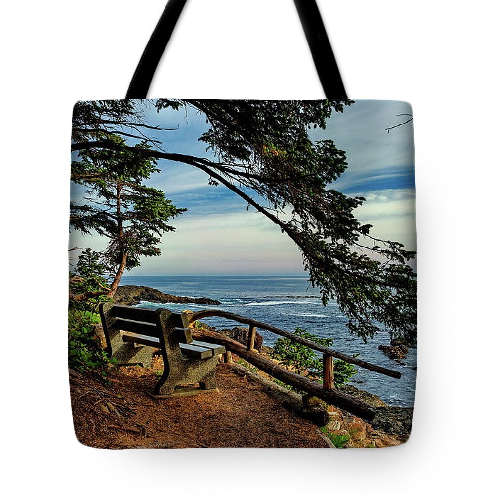  Alex Lyubar Tote Bag featuring the photograph Bench on the cliff over the seashore by Alex Lyubar