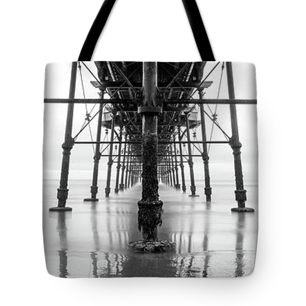 Panorama Tote Bag featuring the photograph Beneath Saltburn Pier Redcar and cleveland Black and white by Sonny Ryse