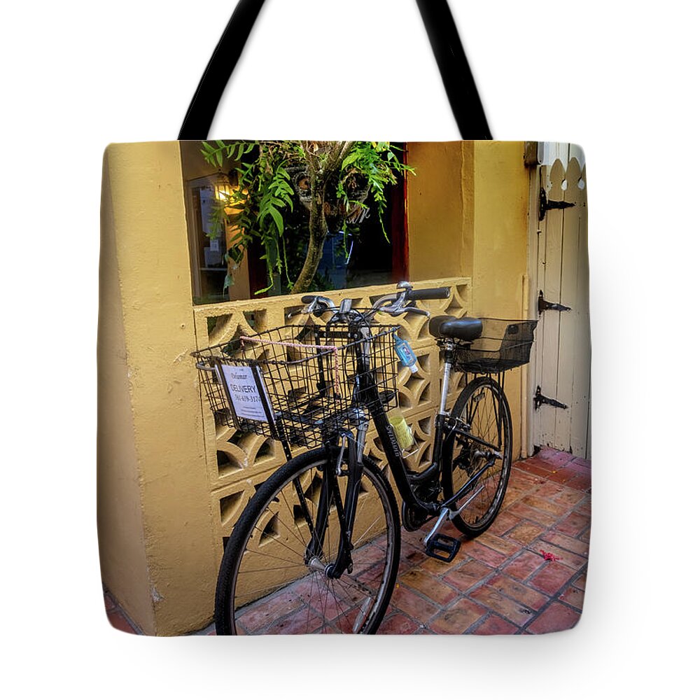 Bicycle Tote Bag featuring the photograph Bicycle in the Courtyard by Debra and Dave Vanderlaan