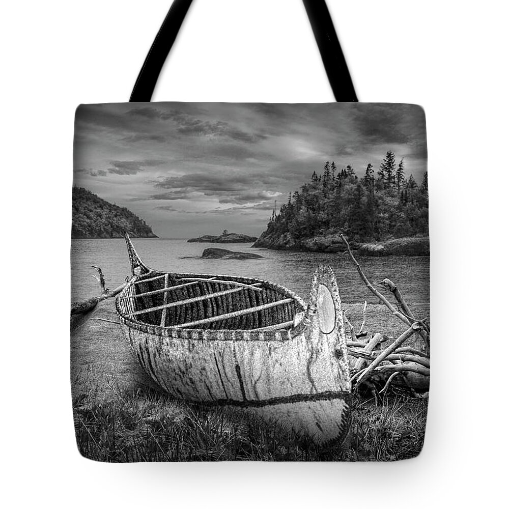 Art Tote Bag featuring the photograph Birch Bark Canoe ashore on Driftwood Beach in Black and White by Randall Nyhof