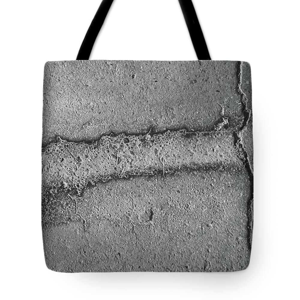 Cracked Pavement Tote Bag featuring the photograph Black and White Series 1-3 by J Doyne Miller