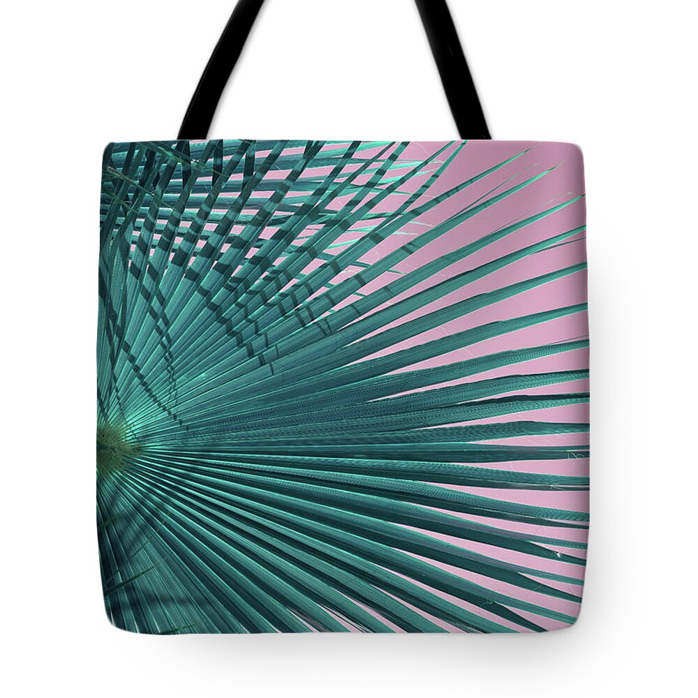 Palm Leaf Tote Bag featuring the photograph Blue-green palm leaf and pink sky, beach season by Adriana Mueller