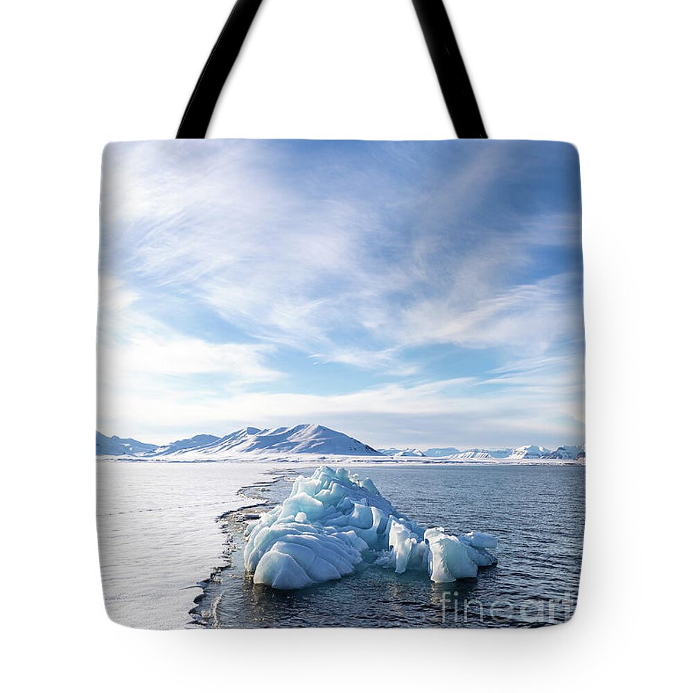 Frozen Tote Bag featuring the photograph Blue iceberg in Svalbard by Jane Rix