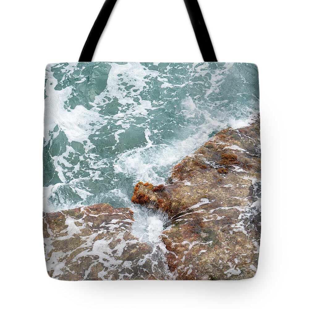 Sea Water Tote Bag featuring the photograph Blue sea water flows over the rocks 1 by Adriana Mueller