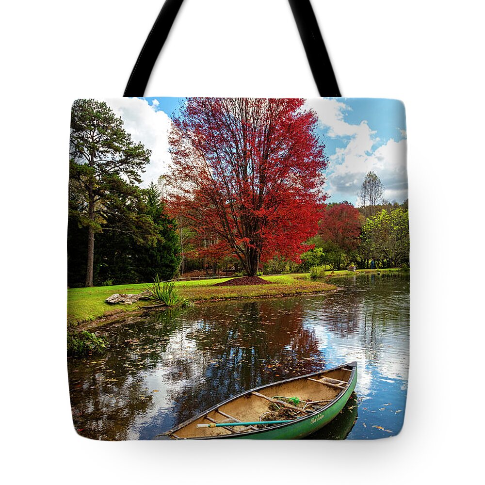 Boats Tote Bag featuring the photograph Canoe at the Red Maple Tree by Debra and Dave Vanderlaan