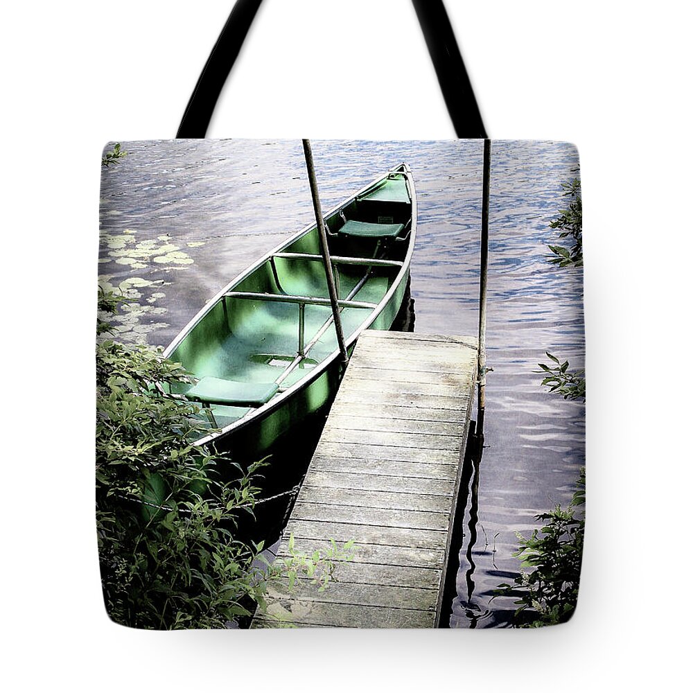 Canoe Tote Bag featuring the photograph Canoe On A Lake by Amelia Pearn