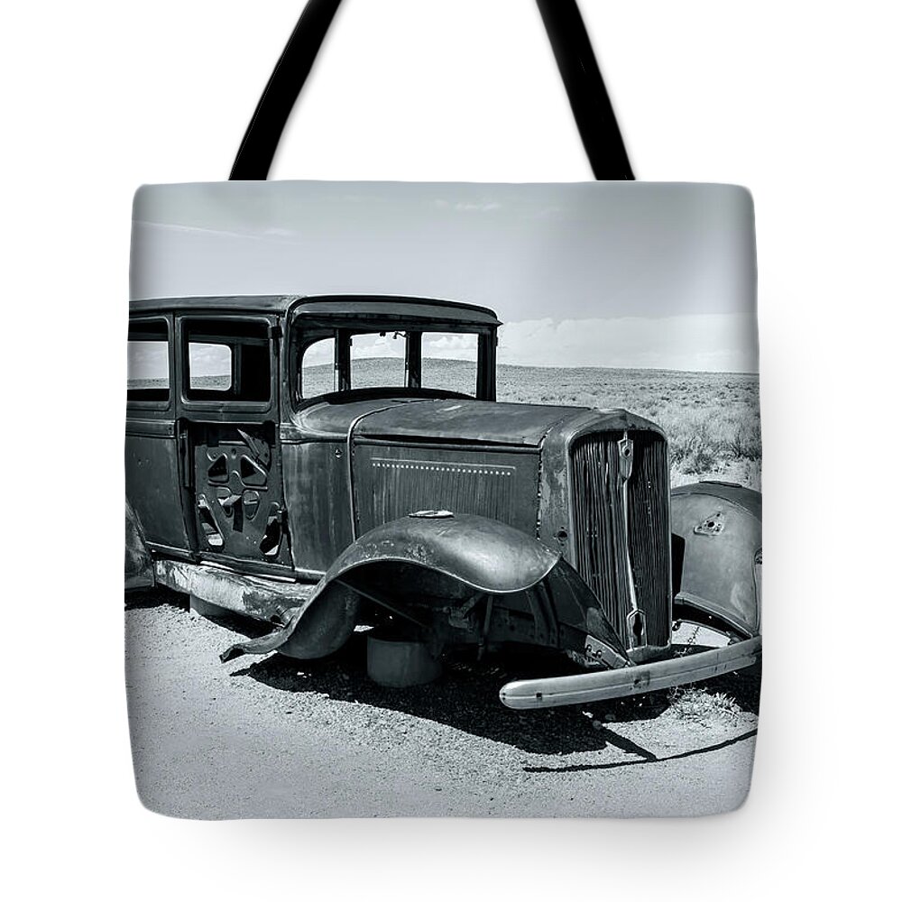 Petrified Forest National Park Tote Bag featuring the photograph Car Skeleton At Rt 66 Bw by Jonathan Nguyen