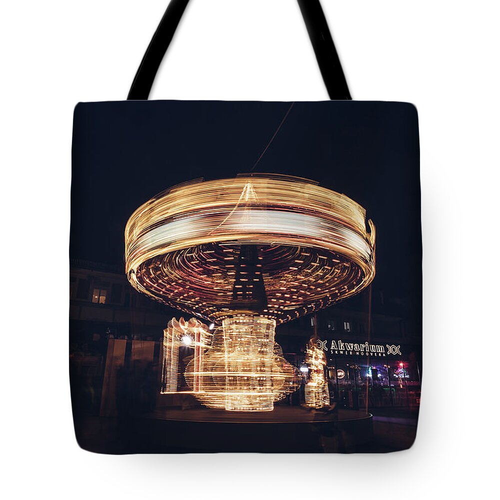 Illuminations Tote Bag featuring the photograph Christmas carousel on the streets of Warsaw. Fire Wheel by Vaclav Sonnek