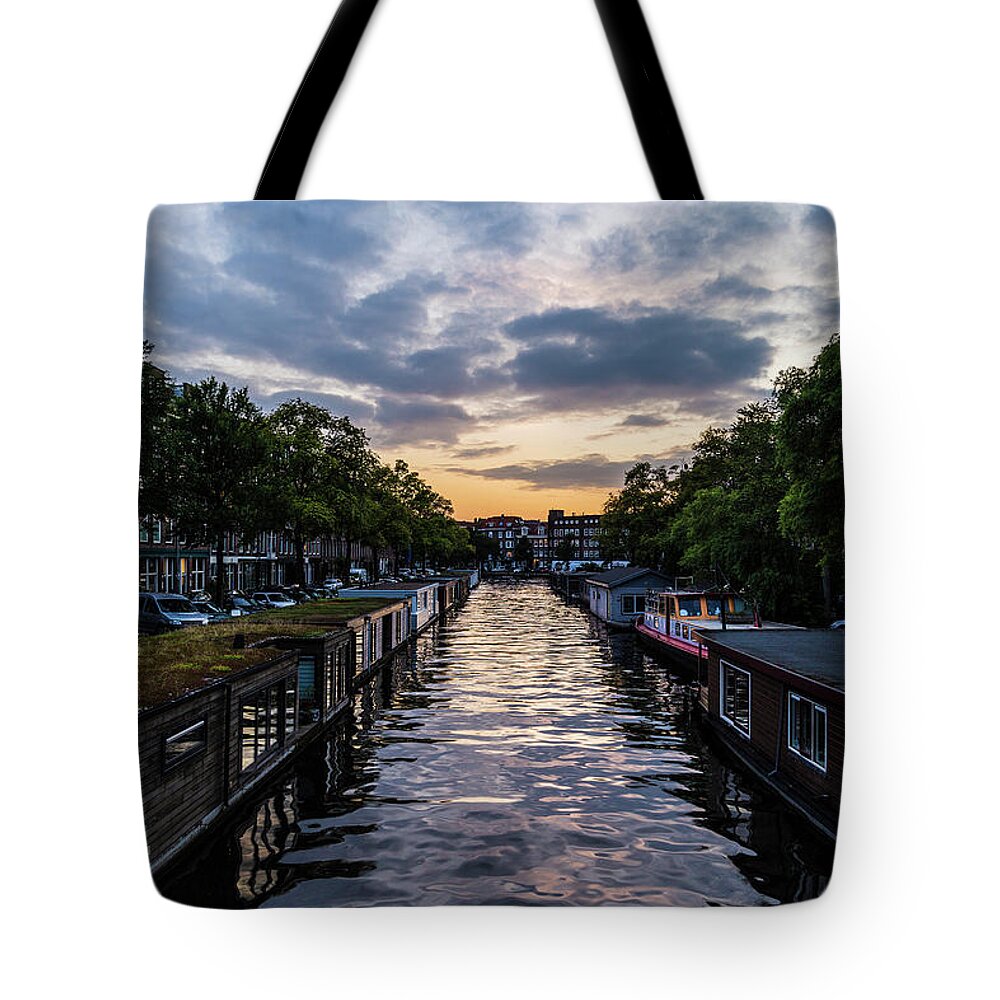 City Tote Bag featuring the photograph City canal at sunset in Amsterdam by Fabiano Di Paolo