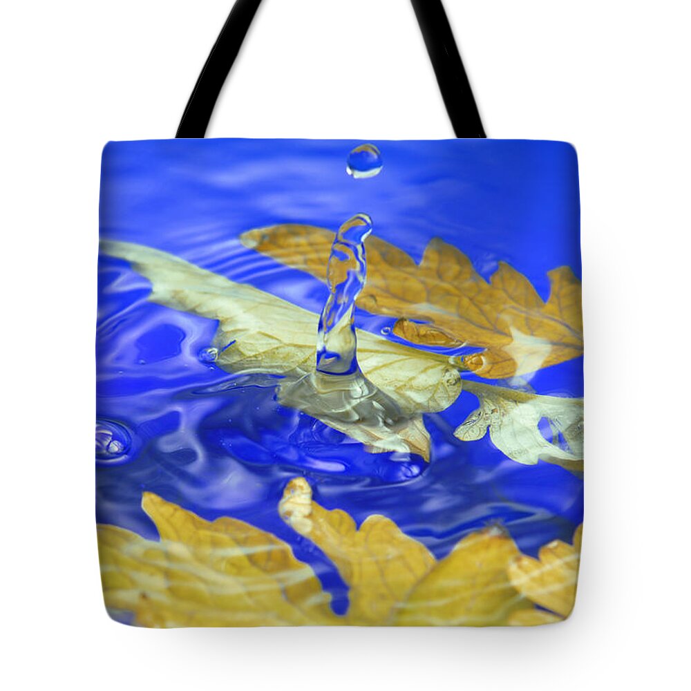 Abstract Tote Bag featuring the photograph Close up of the autumn leaves water splash by Severija Kirilovaite