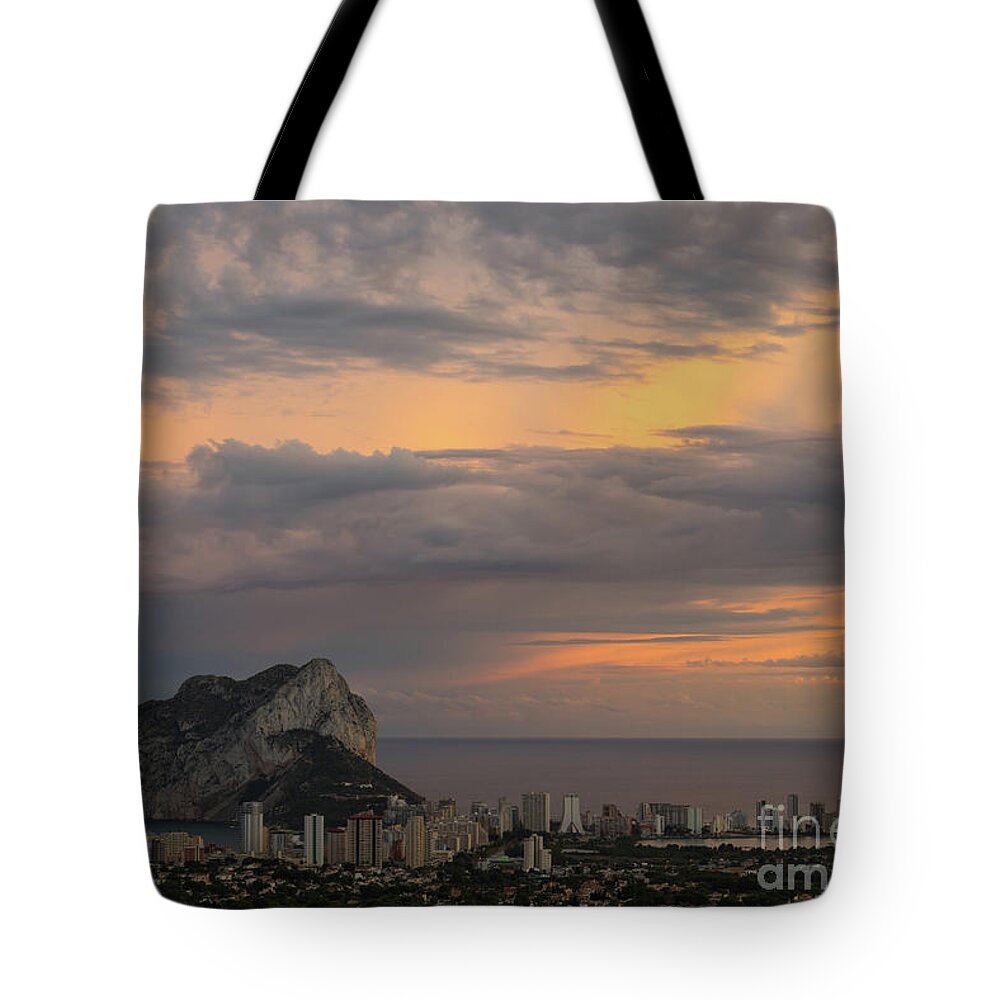 Sunset Tote Bag featuring the photograph Clouds on the Mediterranean coast in Calpe by Adriana Mueller