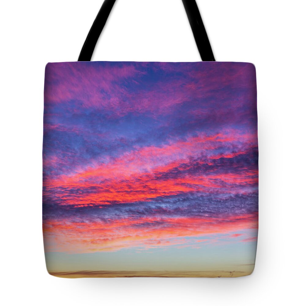 Sunset Tote Bag featuring the photograph Colorful cloudscape at sunset by Fabiano Di Paolo