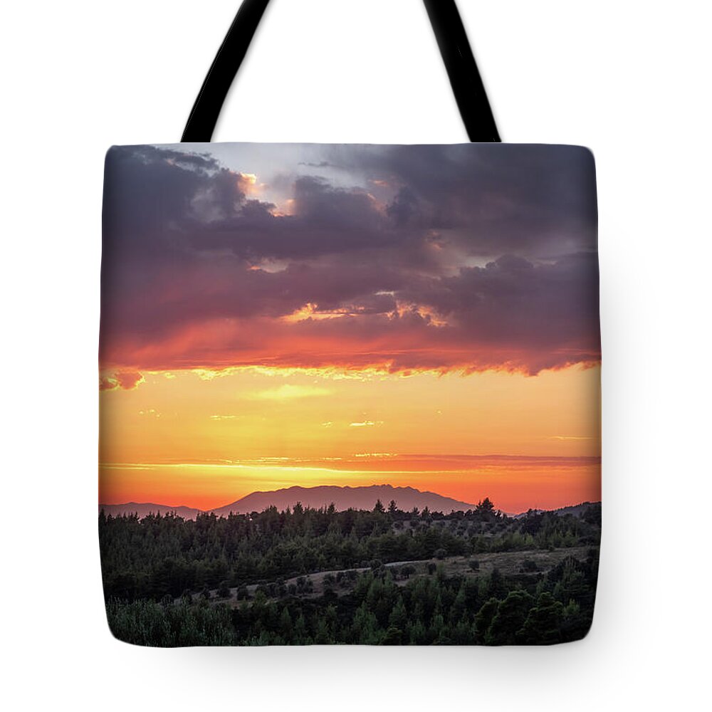 Sunset Tote Bag featuring the photograph Colorful Sunset over a Pine Tree Forest by Alexios Ntounas
