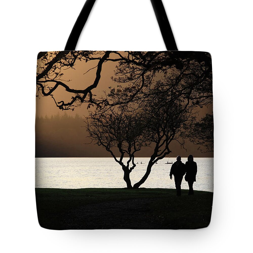 Couple Tote Bag featuring the photograph Couple walking by Derwent Water, Keswick by Bryan Attewell