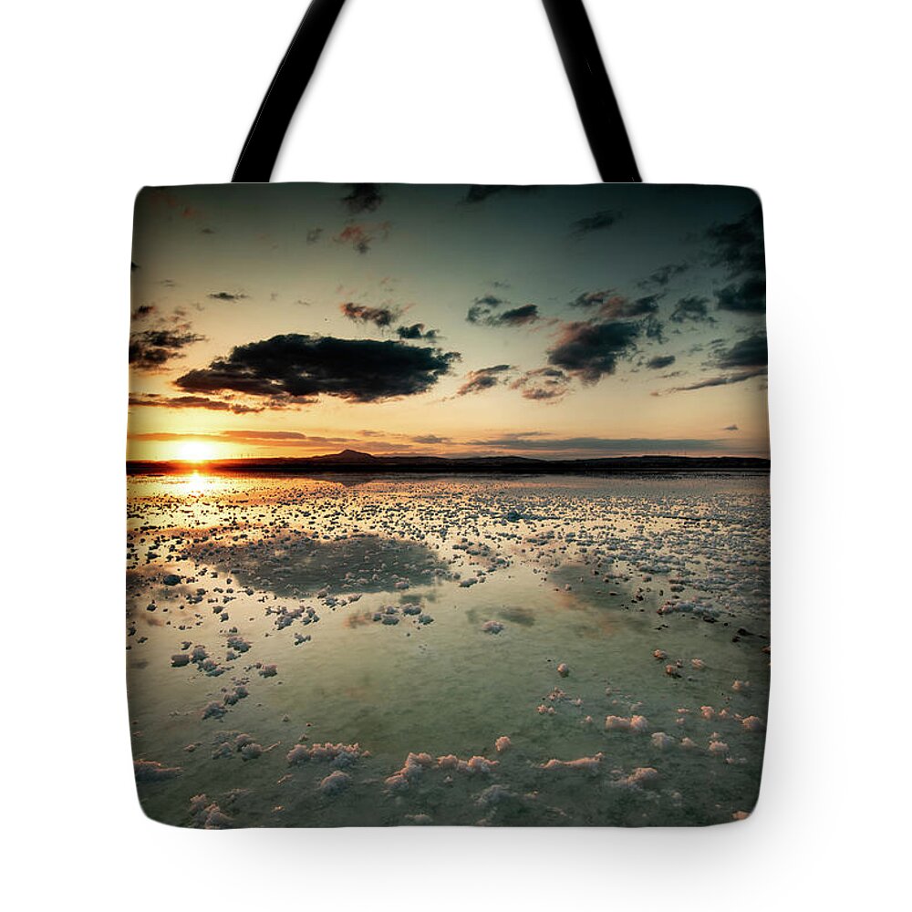 Sunset Tote Bag featuring the photograph Dramatic winter sunset in the lake. by Michalakis Ppalis