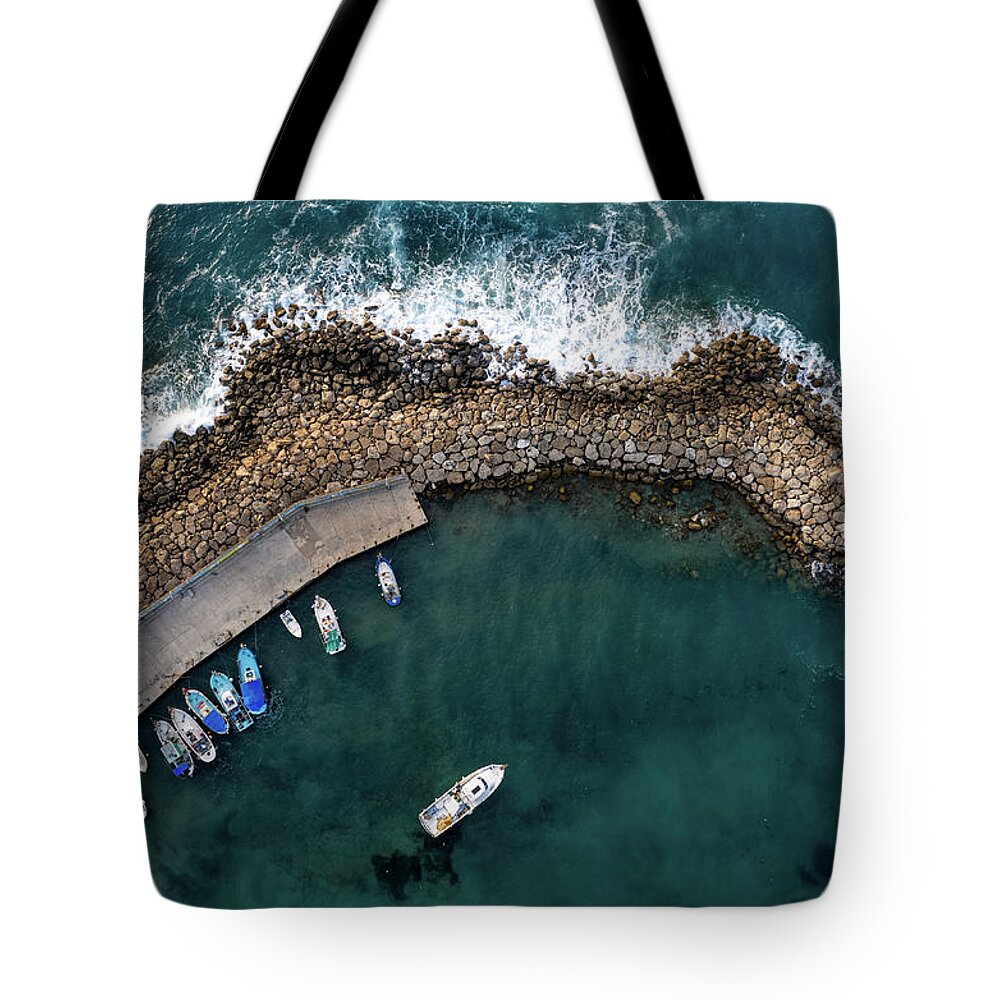 Fishing Harbor Tote Bag featuring the photograph Drone aerial fishing harbour with boats stormy waves, blue sea by Michalakis Ppalis