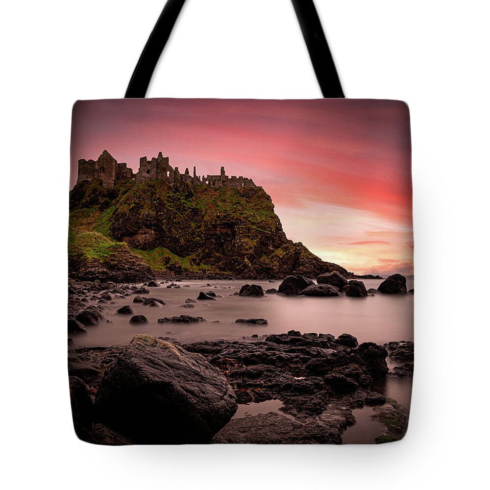 Dunluce Tote Bag featuring the photograph Dunluce Castle Sunset by Nigel R Bell
