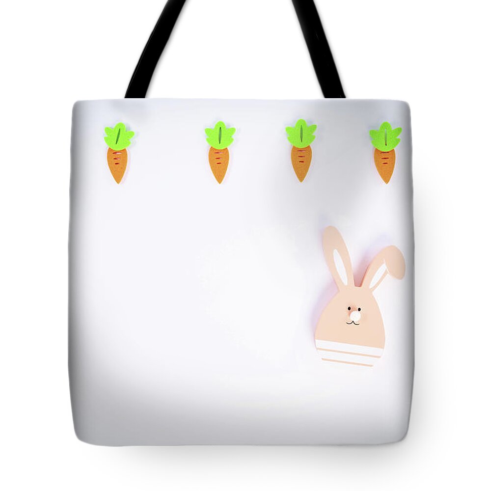 Easter Tote Bag featuring the photograph Easter pattern with carrots and a cute Easter bunny by Mendelex Photography