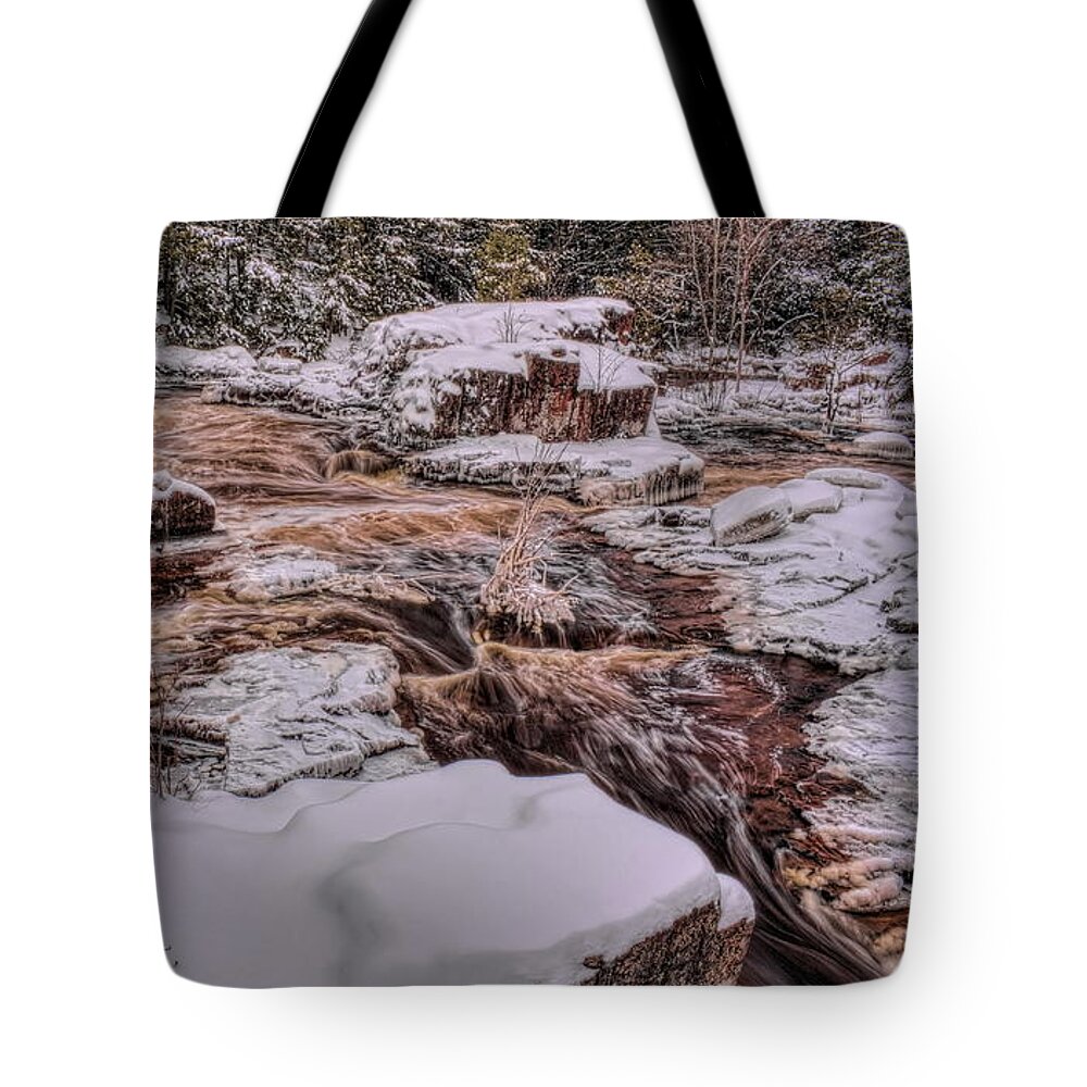 Eau Claire Dells Tote Bag featuring the photograph Eau Claire River Flow Through The Snow by Dale Kauzlaric
