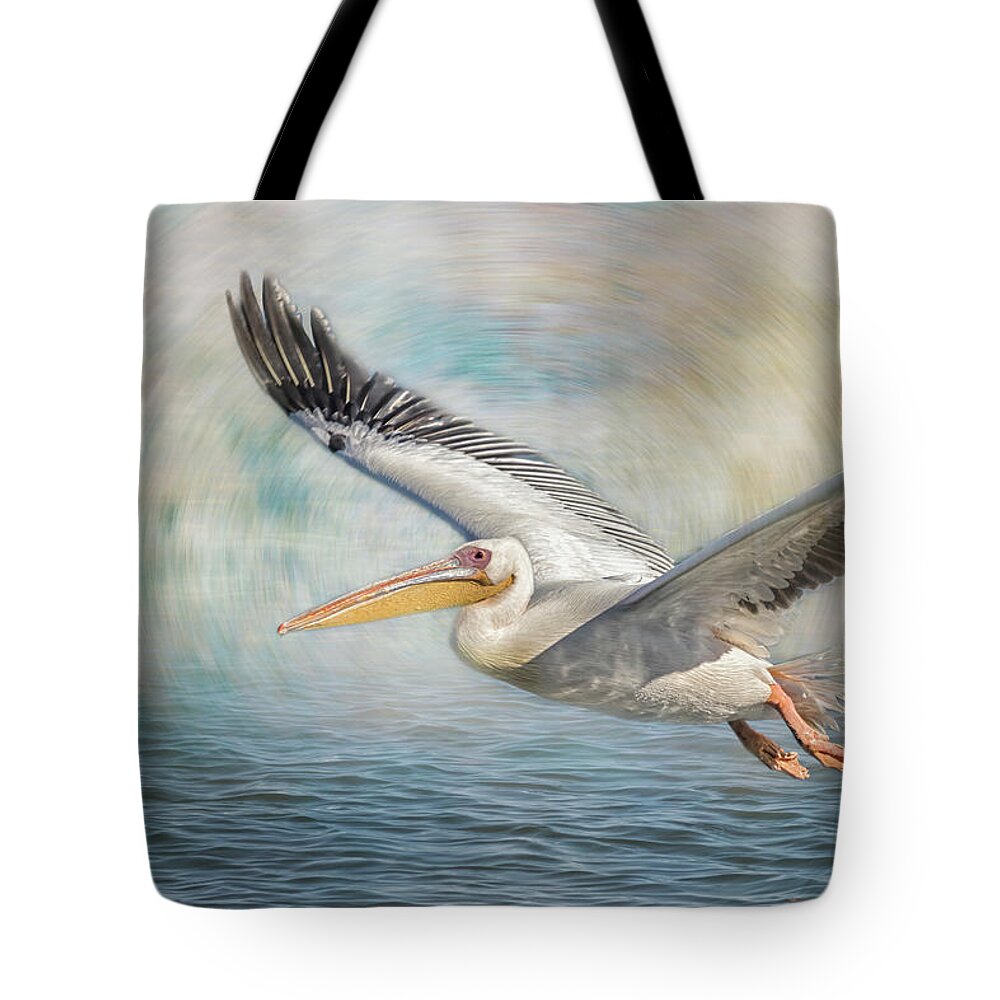 Great White Pelican Tote Bag featuring the photograph Flight of a Great White Pelican by Belinda Greb