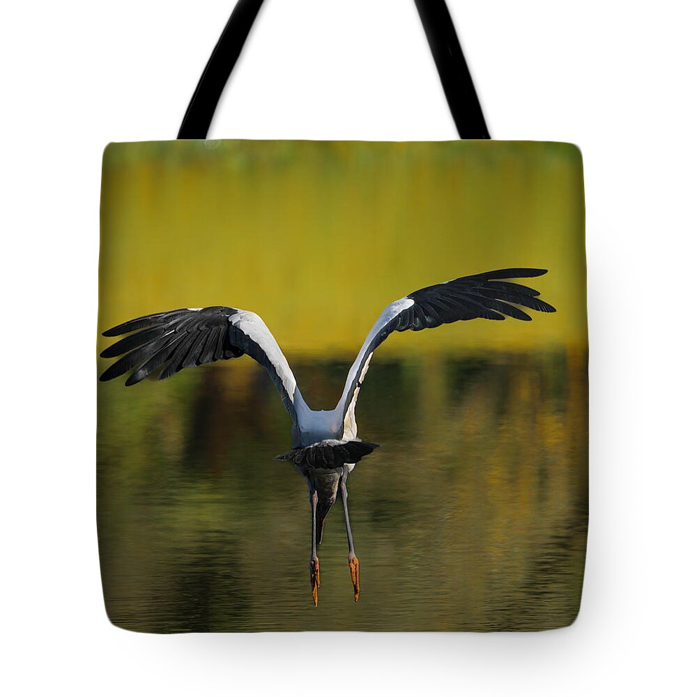 Birds Tote Bag featuring the photograph Flying Wood Stork by Larry Marshall