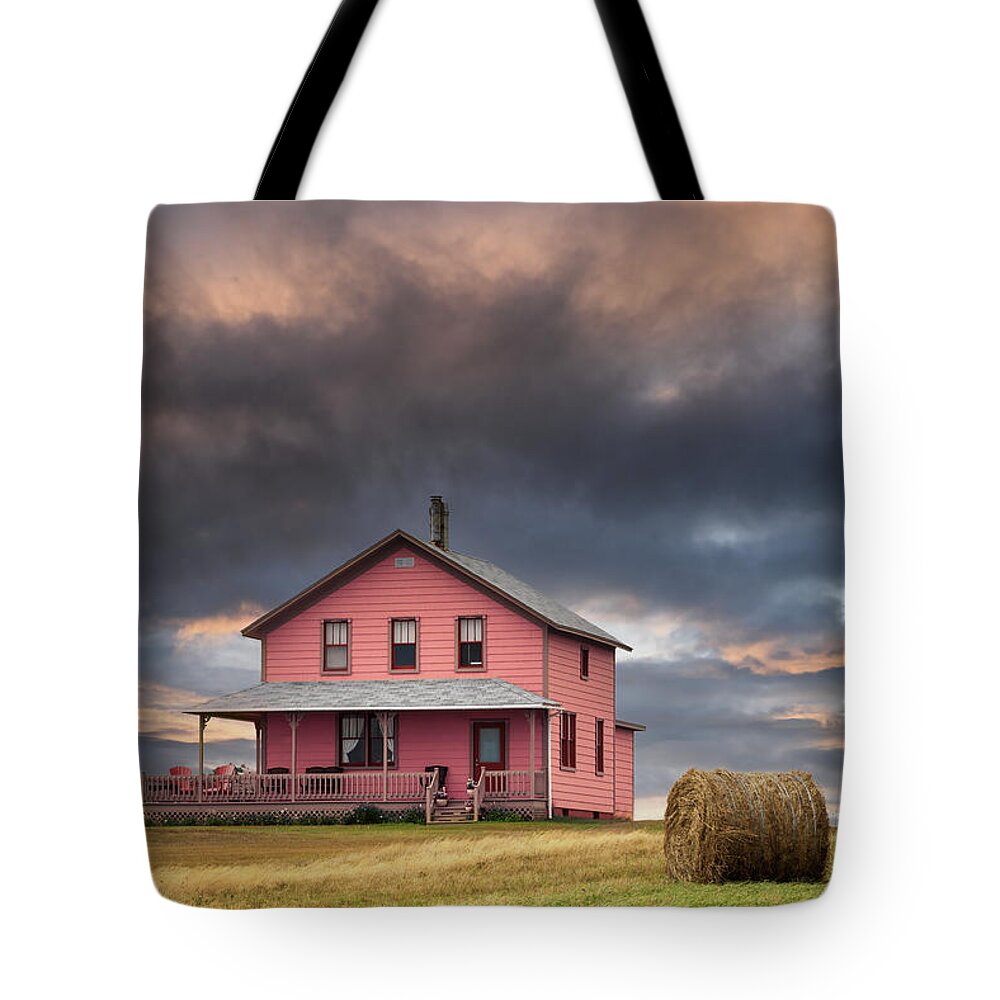 Typical Tote Bag featuring the photograph rchitecture of the Magdalen Islands, where all the wooden houses are brightly painted. Sunset shot of a house on the hill. Image taken from a public position. by Jane Rix