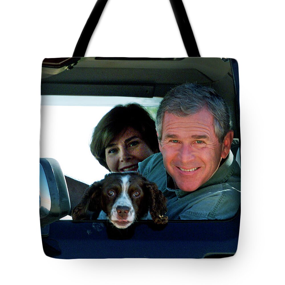 George W. Bush Tote Bag featuring the photograph George Bush and Laura in Truck by Rick Wilking