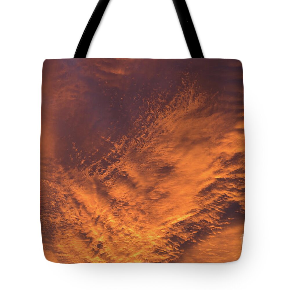Clouds Tote Bag featuring the photograph Glowing sunset sky with deep orange clouds by Adriana Mueller