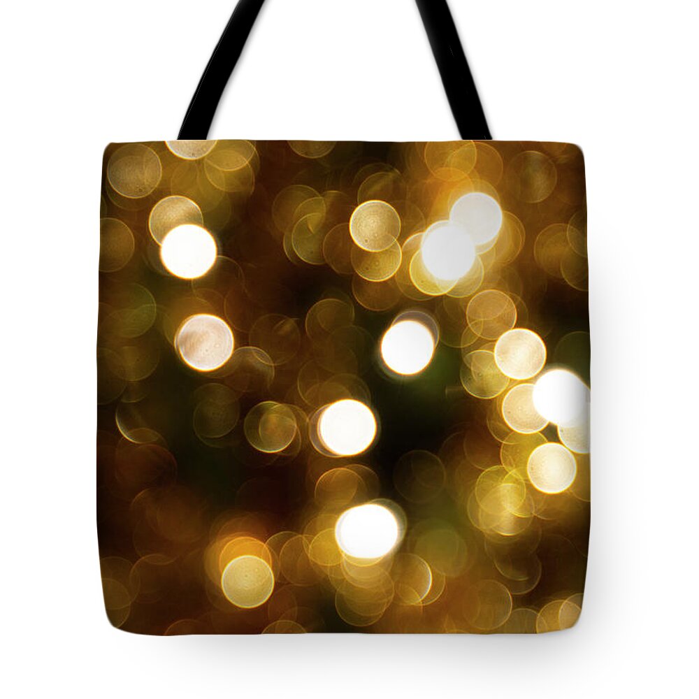 Abstract Tote Bag featuring the photograph Gold bokeh effect by Karen Foley