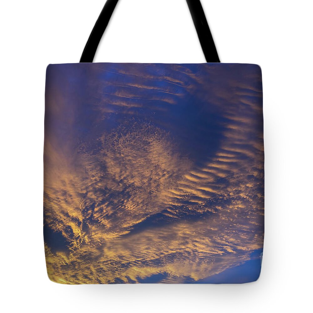 Clouds Tote Bag featuring the photograph Golden and dark blue cloudscape at sunset by Adriana Mueller
