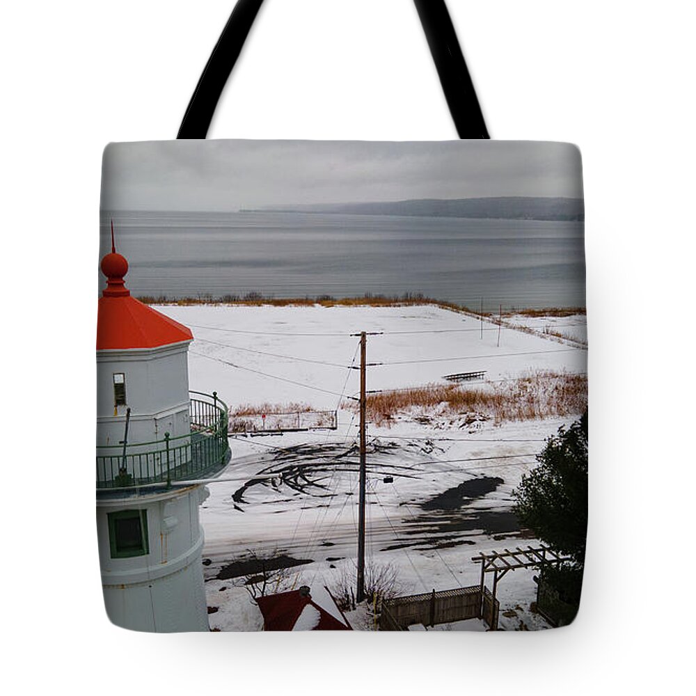 Lighthouse Tote Bag featuring the photograph Grand Island Harbor Lighthouse in Munising Michigan during winter by Eldon McGraw