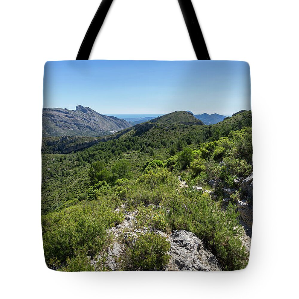 Mountain Tote Bag featuring the photograph Green mountain landscape and the rock Cavall Verd by Adriana Mueller