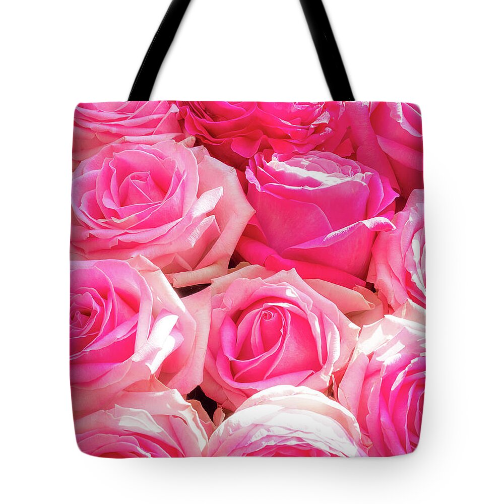 Arrangement Tote Bag featuring the photograph Group of ten pink roses in bloom by Jean-Luc Farges