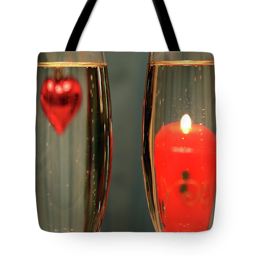 Champagne Tote Bag featuring the photograph Heart And Candle In Glasses With Champagne by Mikhail Kokhanchikov