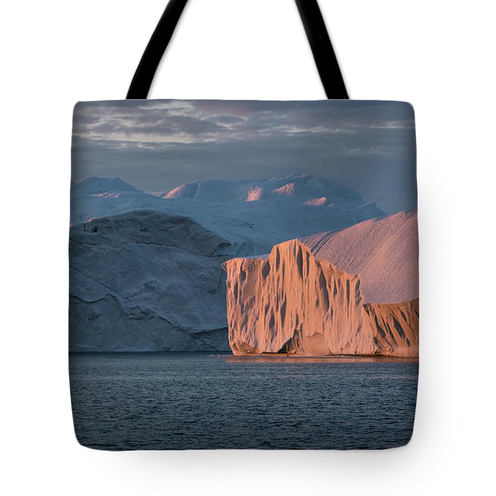Midnight Tote Bag featuring the photograph Icebergs in the midnight sun by Anges Van der Logt
