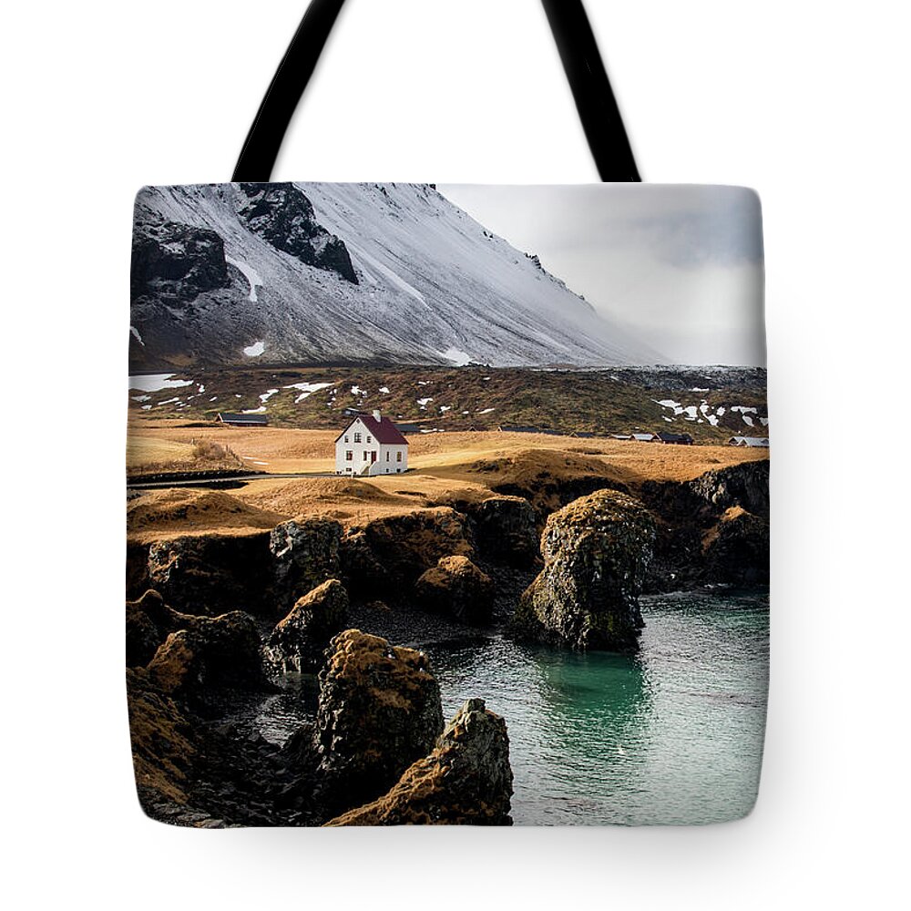 Arnarstapi Tote Bag featuring the photograph Iceland landscape in winter at Arnarstapi village. by Michalakis Ppalis