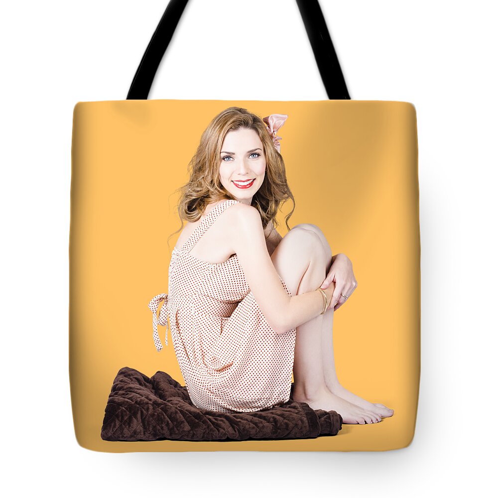 Beauty Tote Bag featuring the photograph Isolated pinup girl sitting on soft blanket by Jorgo Photography