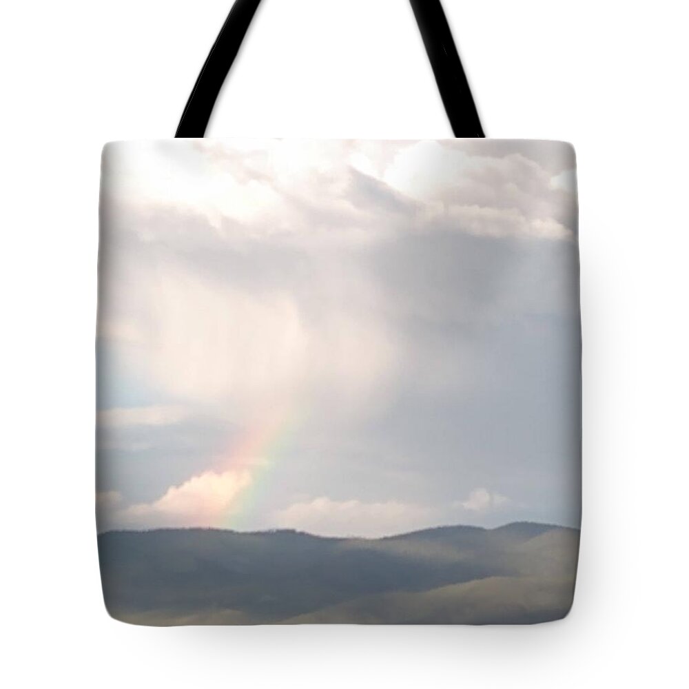 Taos Ski Valley Getting Sprinkled With A Rainbow And Shaded By The Clouds Tote Bag featuring the photograph Just a taste of the Rainbow by Nina Velasquez