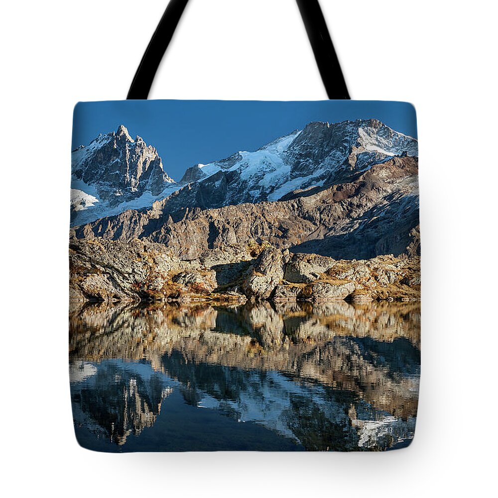 Lake Tote Bag featuring the photograph La Meije peak mirrored in Lake Lerie by Olivier Parent