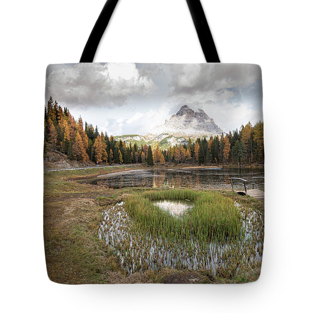 Lago Di Antorno Tote Bag featuring the photograph Lago di antorno lake and Tre cime di lavadero mountain reflection in autumn. Forest landscape South tyrol Italy by Michalakis Ppalis