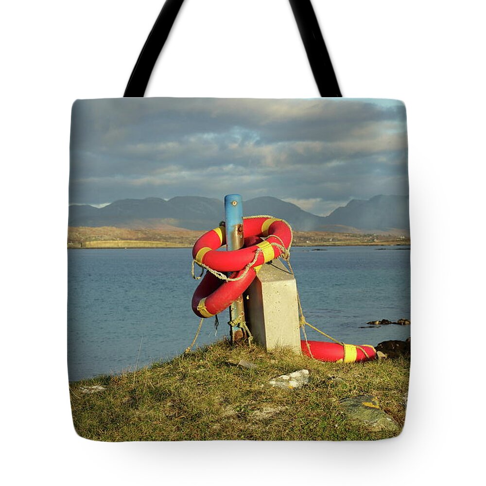 Lifebuoy Connemara Ballyconneely Galway Ireland Saftey Outdoors Ocean Mountains Beach Walking Photography Tote Bag featuring the photograph Life savers by Peter Skelton